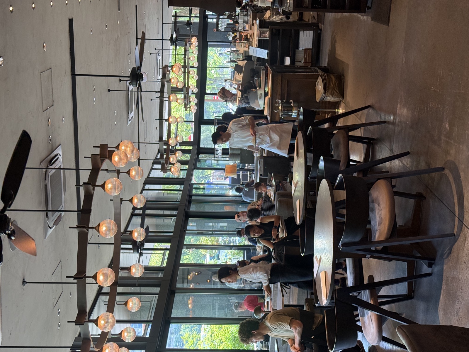 Modern restaurant interior with pendant lights and casual dining seating