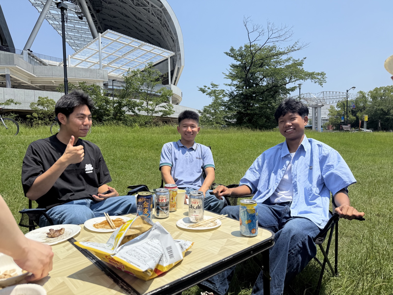 Group of people dining together outdoors near modern architecture in daylight