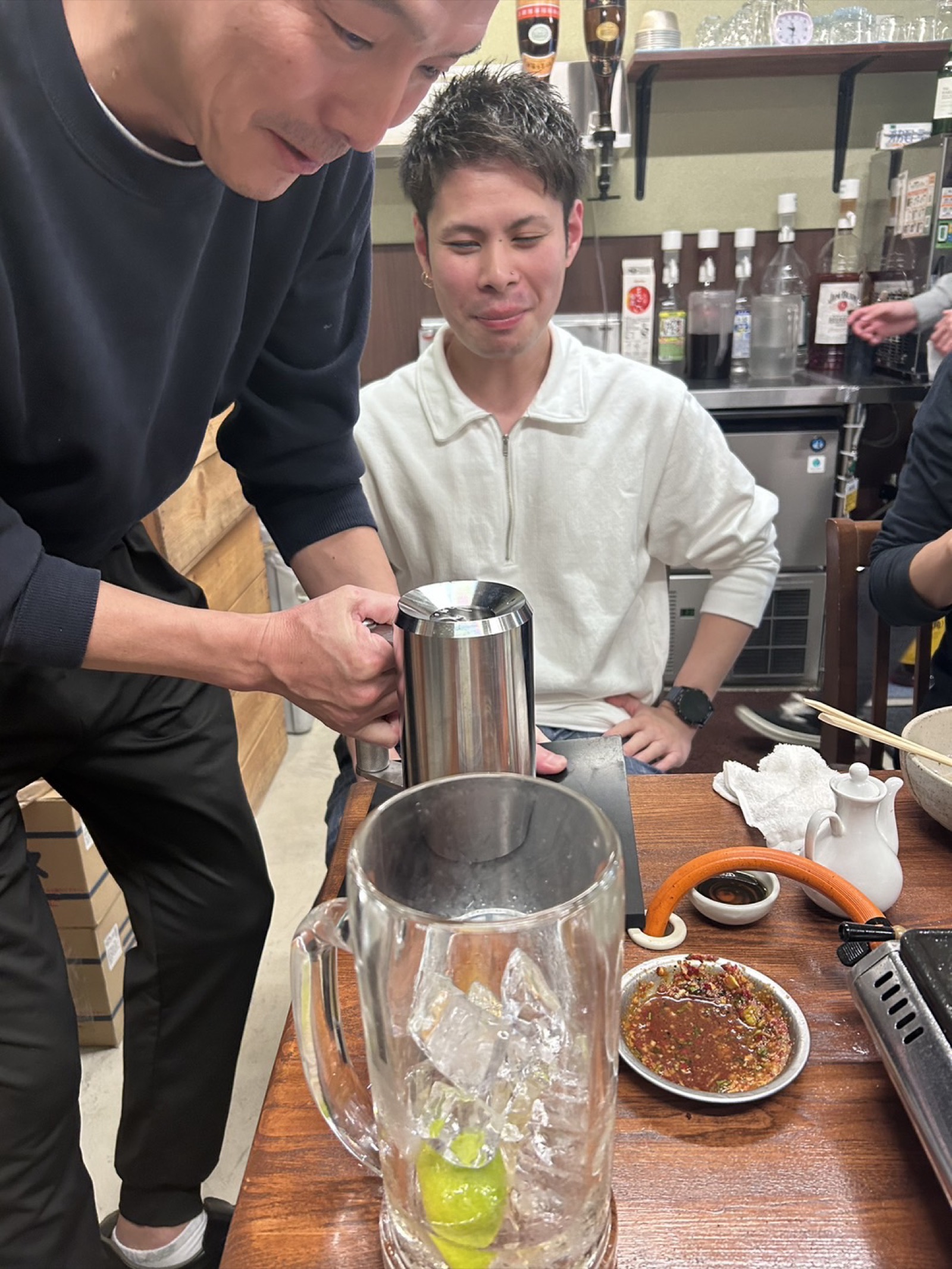 Bartender preparing craft cocktail with precise mixing technique at bar counter