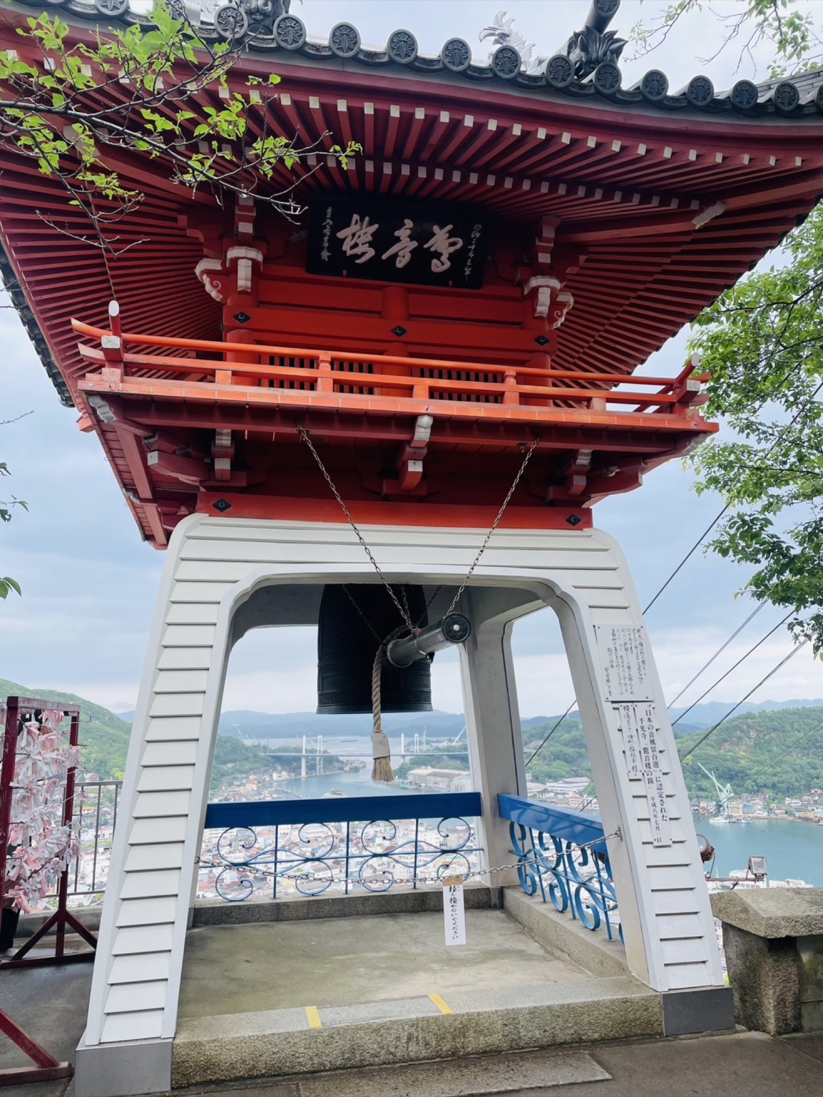 Red pagoda frames scenic Hiroshima riverside landscape with traditional waterfront architecture