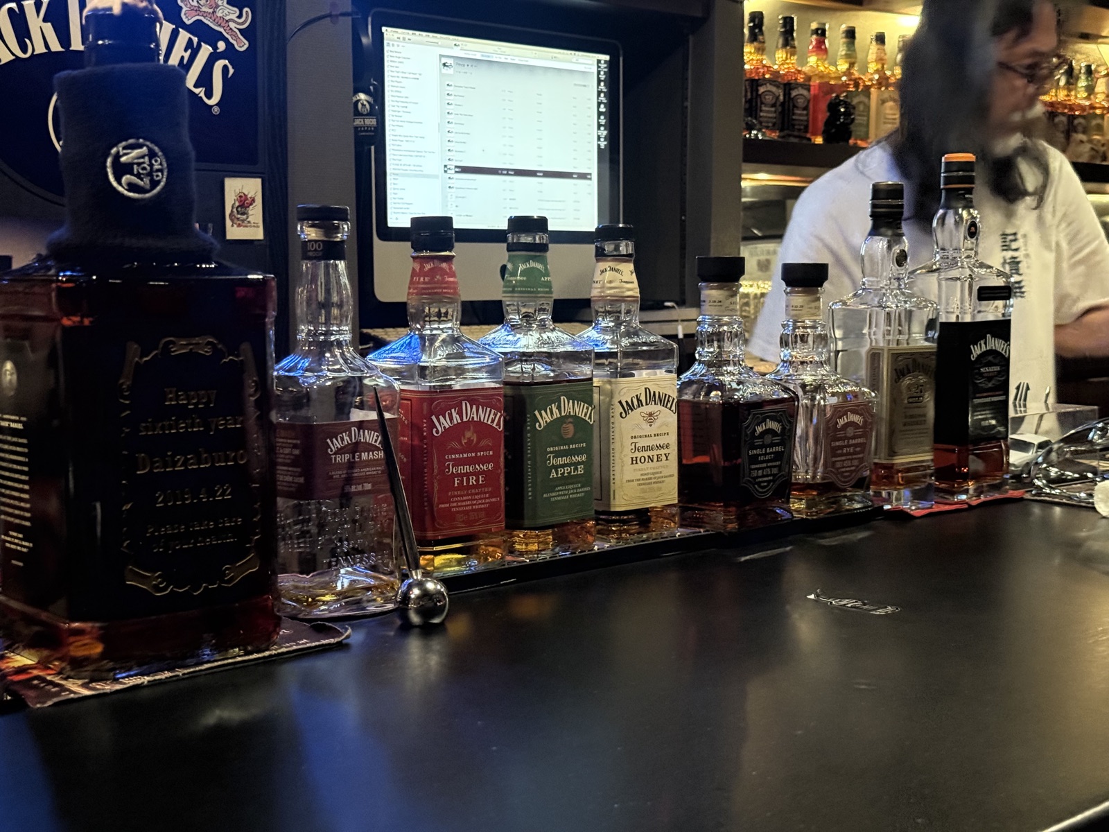 Whiskey bottles and glasses displayed at bar counter