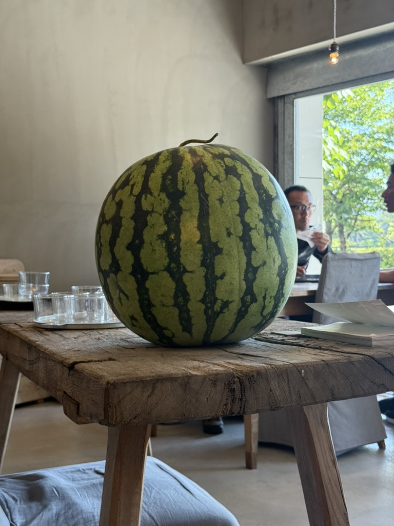 Whole summer watermelon on a wooden cafe table