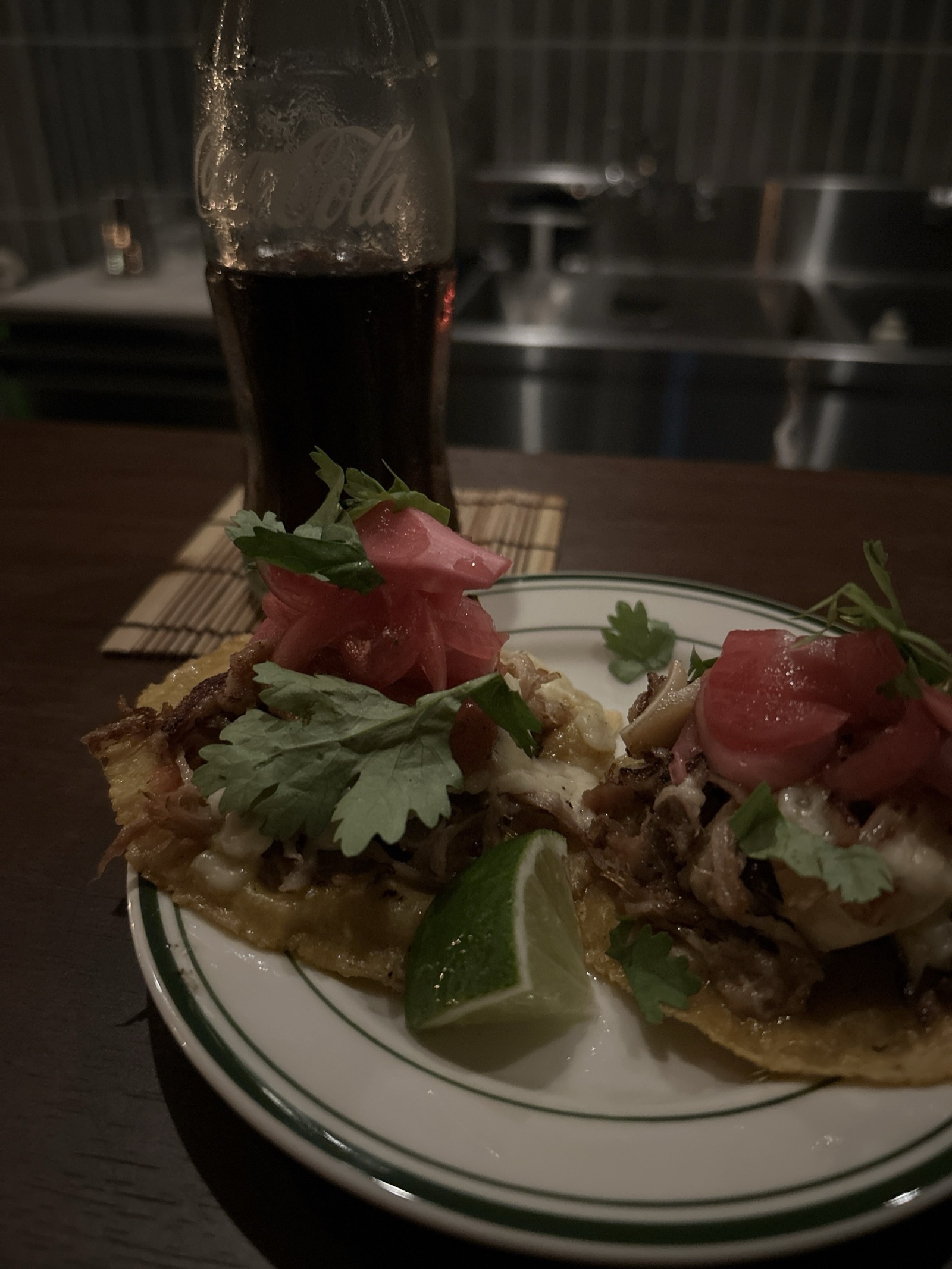 Tacos and a bottled Coke on the counter at VUELTA