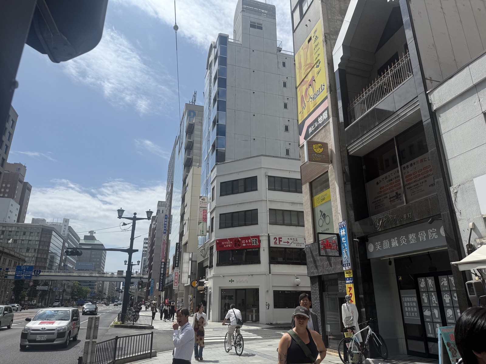 Daytime street scene in downtown Hiroshima with shops and buildings